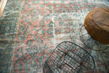 Distressed field of vintage Mahal carpet with oversized floral vinery in blush, sky blue, and sea foam.