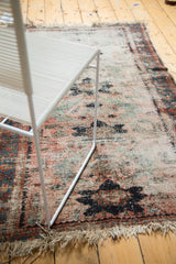 Well-worn vintage Lilihan rug section showing exposed foundation, dusty rose, and tattered fringe.