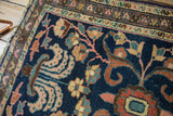 Delicate vinery and blossoms on the cobalt blue field of this vintage Hamadan rug.