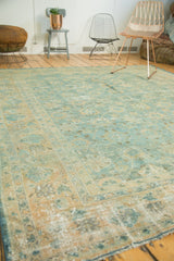 Angled view of vintage Lilihan rug, showing allover botanical design in sky blue and pale copper.
