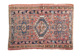 Vintage Karaja rug with triple serrated medallion, geometric motifs, and abrashed blush red field.