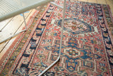 Vintage Karaja rug detail: serrated geometric patterns, hook motif, and abrashed blush red field.