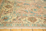 Peach and blue floral palmettes with vinery on vintage Tabriz rug corner, with fringe.
