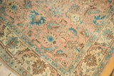 Vintage Tabriz carpet corner with peach, sky blue, and ivory lotus flowers, palmettes, and serrated leaves.