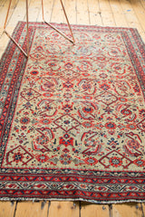 Vintage Malayer rug, detail of pale saffron field Herati motifs, vibrant red borders, tattered fringe.