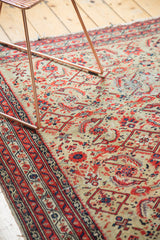 Close-up of vintage Malayer rug: pale saffron field, red and navy Herati pattern, aged pile.