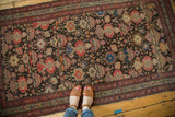 Antique Malayer rug's hand-knotted texture, blush rose and tangerine floral motifs, gentle wear.