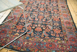 Vintage Hamadan rug detail: indigo field with serrated herati motif and terra cotta border.