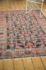 Vintage Hamadan rug featuring an intricate herati motif, multi-toned border, and secure fringe.
