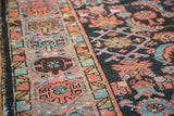 Hand-knotted vintage Hamadan rug, close-up of indigo field's herati motif and geometric border.
