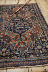 Ornate herati pattern and soft fringe detail on a vintage Senneh rug.