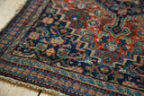 Corner detail of vintage Fine Senneh rug, featuring intricate herati pattern and fringes.