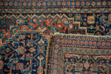 Fine Senneh rug's intricate Herati pile, indigo and rust tones, revealing its hand-knotted back.
