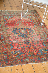 Vintage Farahan Sarouk rug end with tattered fringe and exposed foundation.