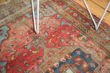 Blush rose and sky blue curvilinear motifs with exposed foundation on the vintage Farahan Sarouk rug.