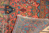 Farahan Sarouk rug close-up of rose pile, intricately woven back, and tattered edge.