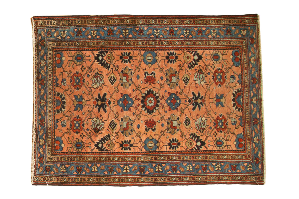 Antique Persian Lilihan rug features allover floral vinery in peach apricot, sky blue, and blush, circa 1910.