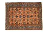Antique Persian Lilihan rug features allover floral vinery in peach apricot, sky blue, and blush, circa 1910.