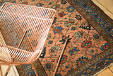Early 20th century Persian Lilihan rug displaying peach apricot field, floral tendrils, and blue border.