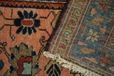 Antique Lilihan rug showing peach floral pile, hand-knotted blue foundation, and fringe.