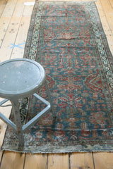 Distressed end of vintage Northwest Persian runner, showing exposed foundation and wear.