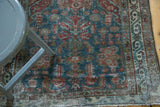 Vintage Northwest Persian runner's muted floral field, ivory geometric border, and visible pile wear.