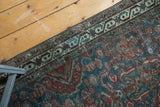 Northwest Persian runner's geometric ivory border and red-patterned field, with foundation showing.