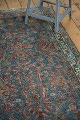 Detailed floral motifs in dark red, blue, and green, showing mostly even wear with foundation visible.