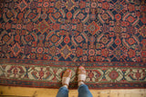 Antique Hamadan runner's Herati field in indigo and blush, detailed ivory border pattern.