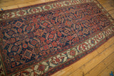 Antique Persian Hamadan rug: indigo field with intricate herati motif and aged ivory floral border.