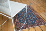 Vintage Hamadan rug corner with intricate Herati motif on a watery blue field and fringed end.