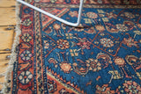 Intricate Herati motif on the vintage Hamadan rug's aqua blue field and tattered fringe.