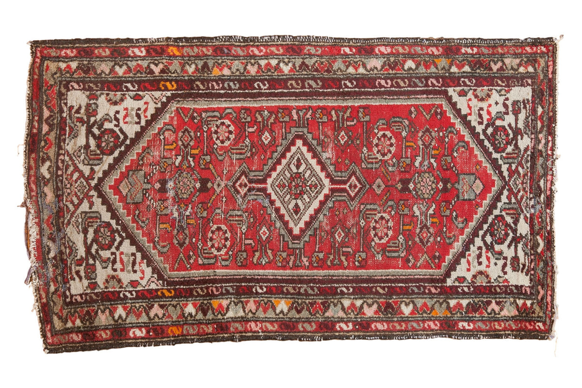 Hand-knotted vintage Hamadan rug with diamond medallion, cinnabar red, ivory, and tattered ends.