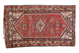 Hand-knotted vintage Hamadan rug with diamond medallion, cinnabar red, ivory, and tattered ends.