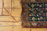 Side view of vintage Kurdish Bag Face rug, highlighting geometric motifs and rustic fringe.