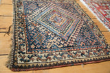 Antique Jaff Kurd rug border with hooked geometric navy, sky blue motifs, tattered side.
