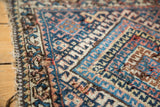 Antique Jaff Kurd rug's geometric navy, sky blue, ivory diamond motif and worn edge.