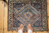 Antique Jaff Kurd rug, concentric diamond and hook latch motif in navy, coral, and beige.