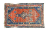 Antique Persian Malayer rug, rust red field, central diamond medallion, aqua blue corners and worn edges.