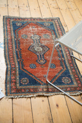 Antique Fine Malayer rug's lower corner, highlighting worn fringe, rust field, and intricate blue border.