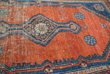 Faded cinnabar red field, diamond medallion, and foundation wear on antique Malayer rug.