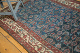 Traditional Persian Malayer rug field and border, indigo, red, ivory, showing even wear.