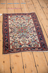 Angled view of a finely woven antique Hamadan rug showing its curvilinear floral design.