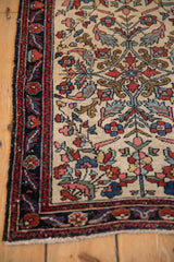 Detailed view of the antique Hamadan's corner showing intricate florals and serrated leaves.