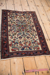 A full display of the antique Hamadan rug's intricate curvilinear design and rich palette of blush, blue, and red.