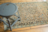 Vintage Persian Sarouk rug's fringed edge and charcoal floral border.