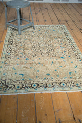 Ivory fringe and charcoal border of vintage Sarouk rug with sky blue motifs.