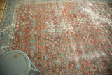Vintage Mahal carpet's corner showing ruby red floral motifs, powder blue border, and abrashes.