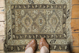 Vintage Caucasian rug, geometric stepped diamond medallion, pinwheel field, neutral tones.