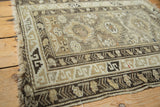 Vintage Caucasian rug corner, geometric patterns in charcoal brown and ivory, with light tatter.